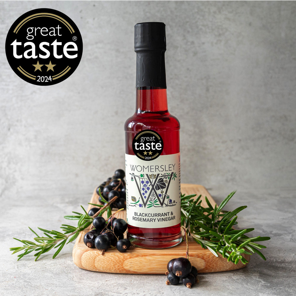 Womersley Foods Blackcurrant and Rosemary Vinegar 150ml bottle with fresh blackcurrants and rosemary sprigs - Great Taste Award 2024 winner