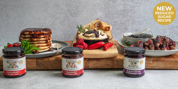 Womersley Foods reduced sugar jam range. Consisting of our Raspberry & Chilli, Strawberry & Mint and Blackcurrant & Rosemary, all in 215g jars and surrounded buy fruit ingredients and prepared foods. 